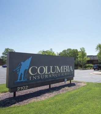 Columbia Insurance Group sign in front of Home Office building. 